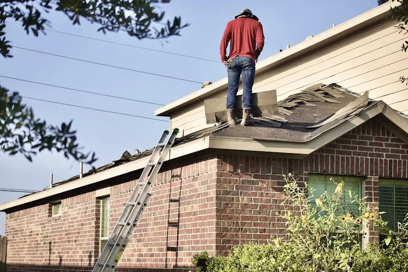 Professional roofer working on a residential roof in Oak Land